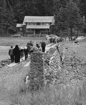 People walking across the causeway from the Chapel toward the lodge, 1940’s